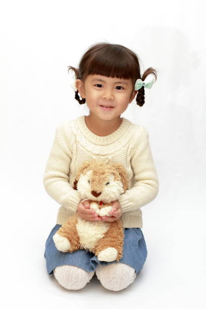 istock Japanese girl holding a stuffed rabbit (4 years old) (white back) 1097868974