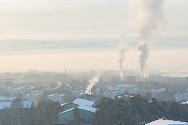 istock Smokes coming from chimneys in city 1097874366