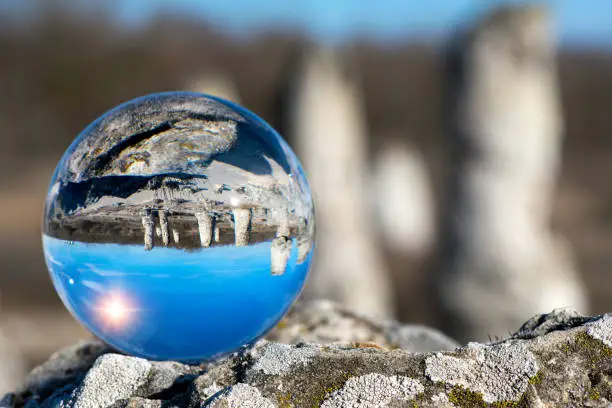 Photo of Upside down landscape of Pobiti Kamani, The Stone Forest Natural Reserve near Varna in Bulgaria, Eastern Europe - reflection in a lens ball - selective focus, space for text