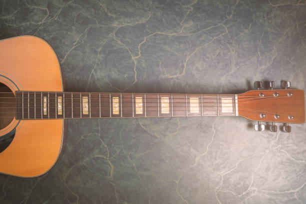 istock acoustic guitar from above on green marble 1097879090
