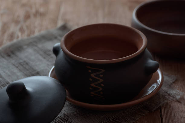 istock Empty clay baking pot with lid on wooden table. Kitchen set. 1097881016