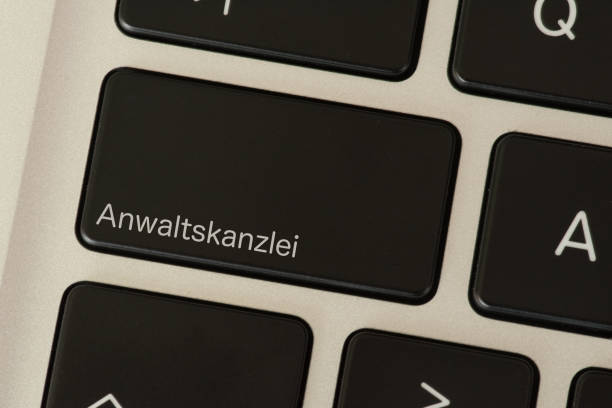istock A computer and a button with the imprint law firm 1097882546
