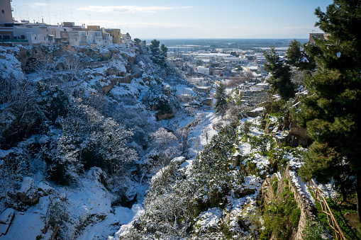 Horizontal View of the Gravina of the Town of Massafra, Covered by Snow on Blue Sky Background. Massafra, Italy