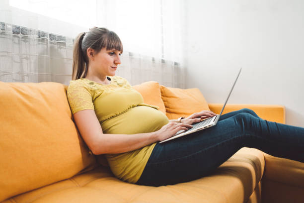 istock Pregnant woman working on laptop 1097887734