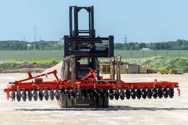 istock Forklift transports disc harrow. Transportation equipment 1097890588