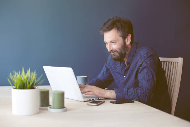 istock Focused middle-aged businessman working from home office 1097892436