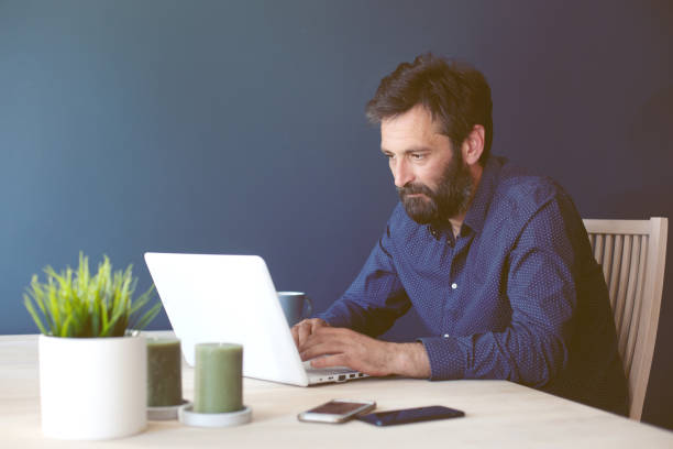 istock Middle aged business man working from his home office 1097892486