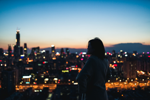 Young Female Overlooking the Stunning View Of City