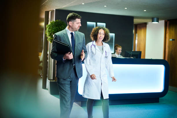 istock pharma representative with doctor in clinic 1097903408