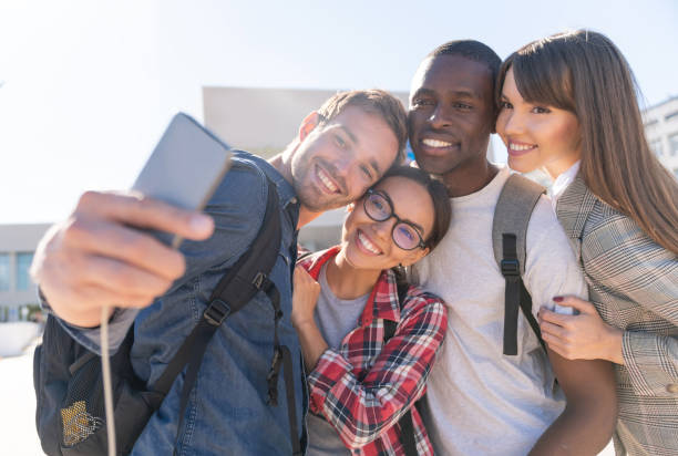 istock Happy group of students taking a selfie outdoors 1097904270