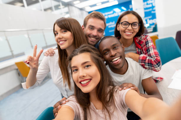 istock Happy group of students taking a selfie in the classroom 1097904328
