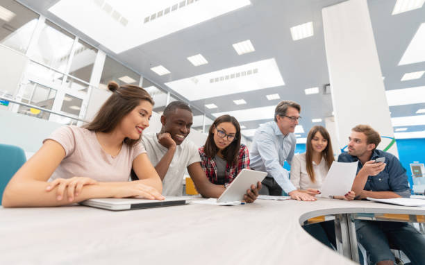 istock Teacher talking to a group of students in class 1097904502
