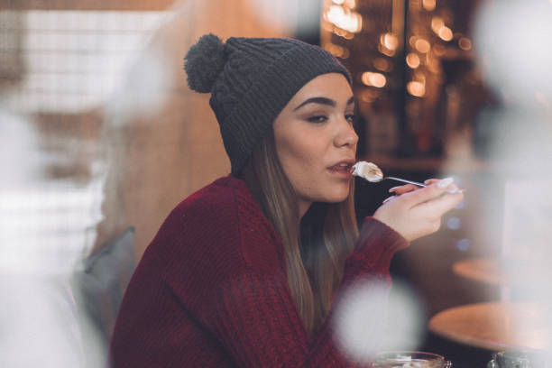 istock Beautiful woman eating breakfast at cafe 1097906692