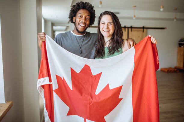 istock Couple holding Canadian Flag 1097909268