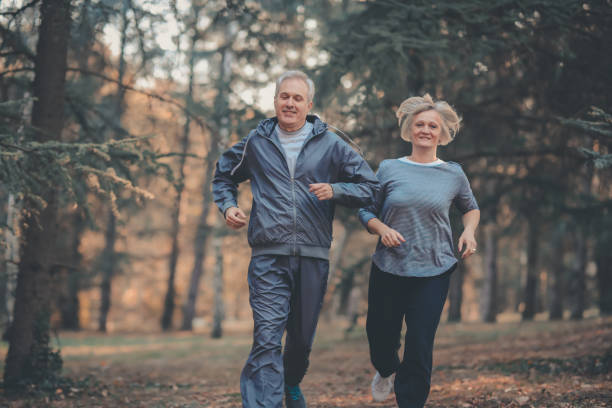istock Senior couple jogging in a forest 1097910722