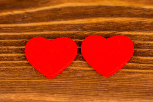 istock pair red valentine's day hearts on rustic wooden background 1097910750