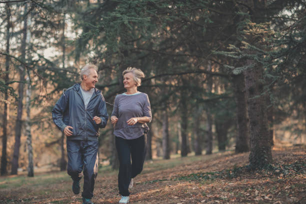 istock Senior couple jogging in a forest 1097910814