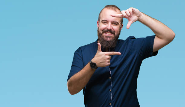 istock Young caucasian hipster man over isolated background smiling making frame with hands and fingers with happy face. Creativity and photography concept. 1097918342