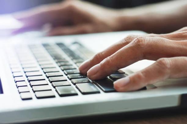 istock close up hands typing keyboard laptop 1097918538