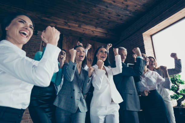 istock Low below angle view of nice cheerful positive optimistic elegant classy stylish trendy professional business people sharks celebrating company progress at workplace station 1097923432