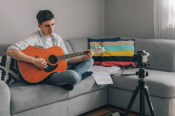 istock Young vlogger, guitarist filming his vlogg 1097923770