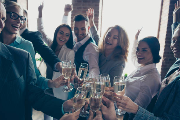 close up photo of large big company of people having fun in office drinking golden beverage glad to have christmas holidays cheers all dressed in formal wear jackets shirts suits - party business toast champagne imagens e fotografias de stock