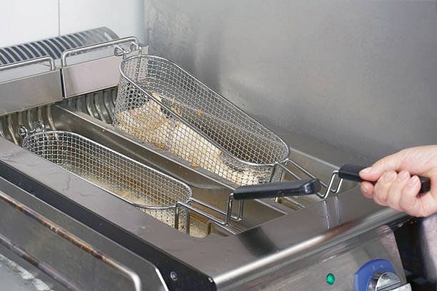 istock Man fries fish in a deep fryer. 1097923826