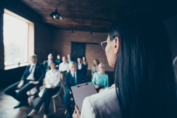 istock Seminar briefing teach mentor couch train big many large nervous staff audience executive diverse concept. Back behind rear close up view of smart careful listening investors sit on chair new person 1097924236