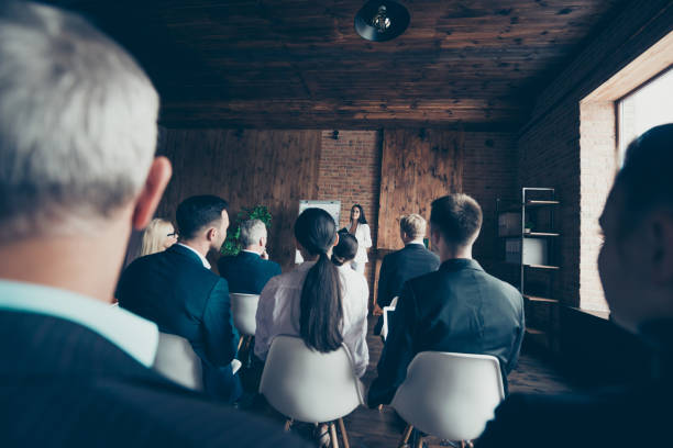 istock Collaboration unity community lecture seminar large staff director concept. Back behind rear view of confident successful professional ceo boss chief speaker telling to new startup to mature personnel 1097930328