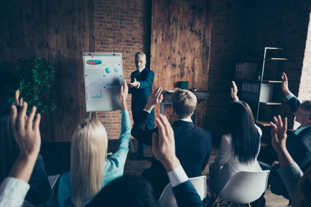 istock Speak speaker speech summit vote faculty course academy concept. Back behind rear view photo of many large public sit on chair listen to smart mentor in loft interior room 1097930454