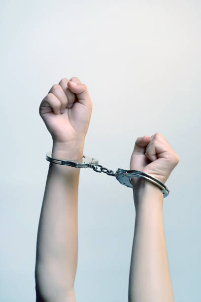 istock Criminal hands locked in handcuffs. 1097930470
