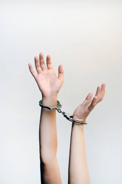 istock Criminal hands locked in handcuffs. 1097930524