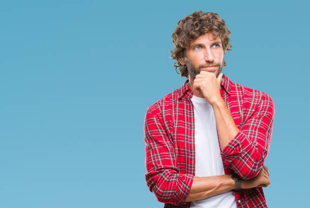 istock Handsome hispanic model man over isolated background looking confident at the camera with smile with crossed arms and hand raised on chin. Thinking positive. 1097931200