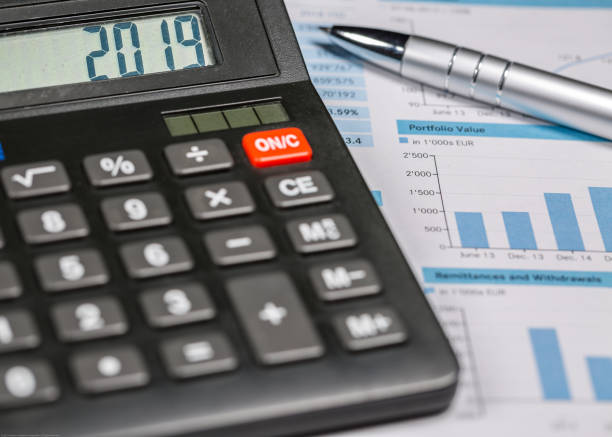 istock Calculator with 2019 digits lie on financial document and pen are on the desk 1097933630