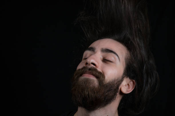 istock Happy man shakes his hair 1097940428