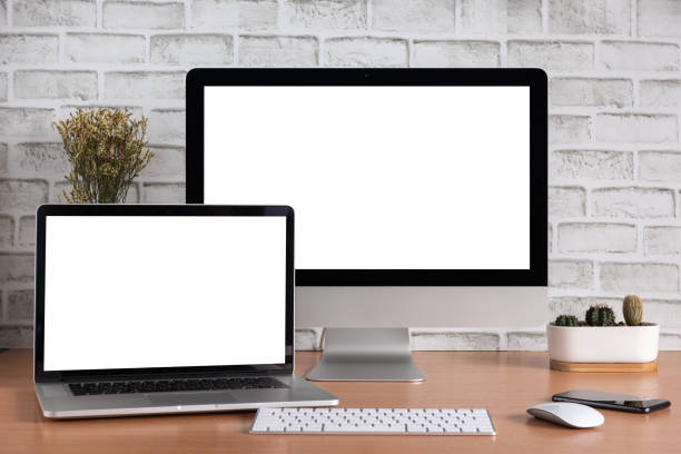 istock Blank screen of all in one computer and laptop computer with smart phone and cactus vase 1097946400