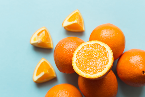 Fresh oranges on the blue background
