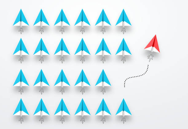istock Group of paper planes in one direction, Red paper plane are leaving group. 1097950238