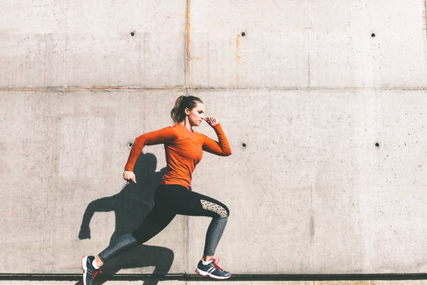 istock young sportswoman running in front of concrete wall 1097951252