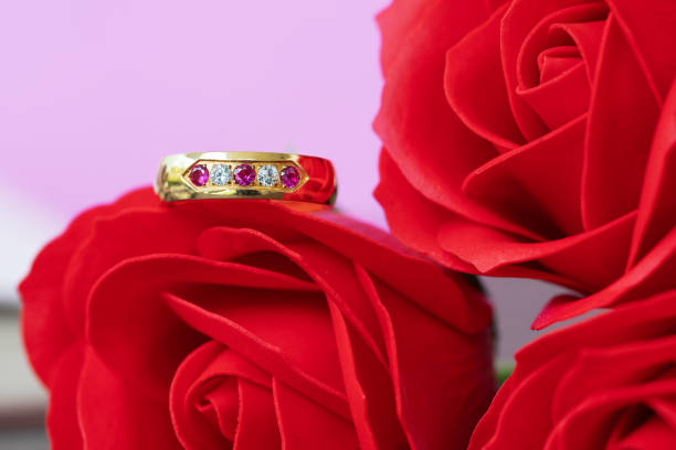 istock Close up wedding ring and red rose 1097951910