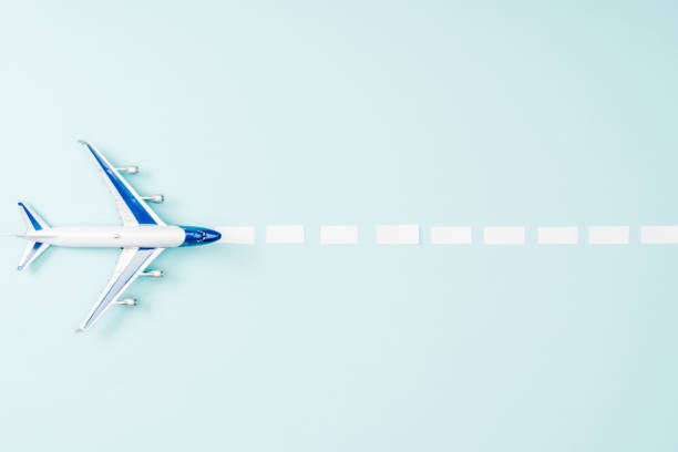 istock top view of toy plane and dotted line on blue background 1097952308