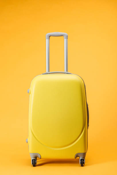 istock travel bag with wheels and handle on yellow background 1097952348