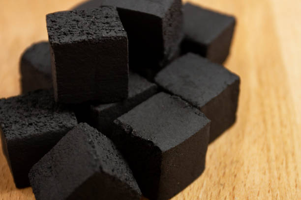 istock Coconut coals for hookah cubes on wooden background 1097954612
