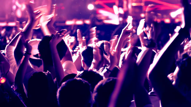 istock abstract colorful background audience in public concert. 1097954992
