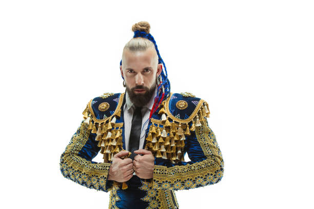 Torero in blue and gold suit or typical spanish bullfighter isolated over white studio background. The taming, achieving the goal, mortification, conquest, boss, leadership, battle, win, winner concept