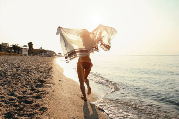 istock Woman running on the beach 1097955894
