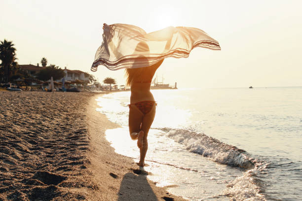 istock Woman running on the beach 1097955904