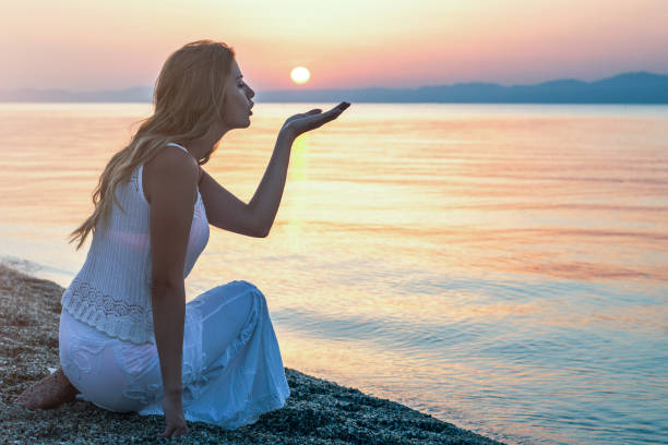istock Woman enjoy on the beach at sunset 1097957184
