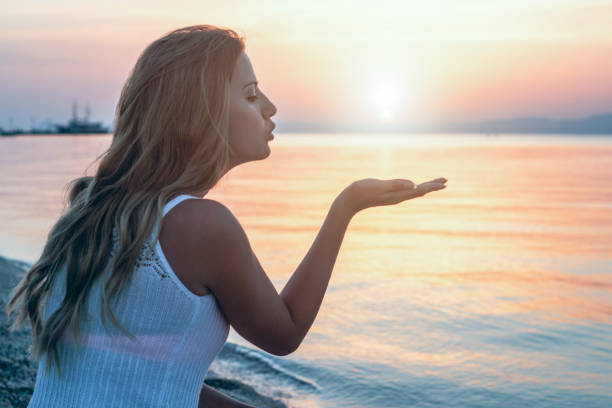 istock Woman enjoy on the beach at sunset 1097957210