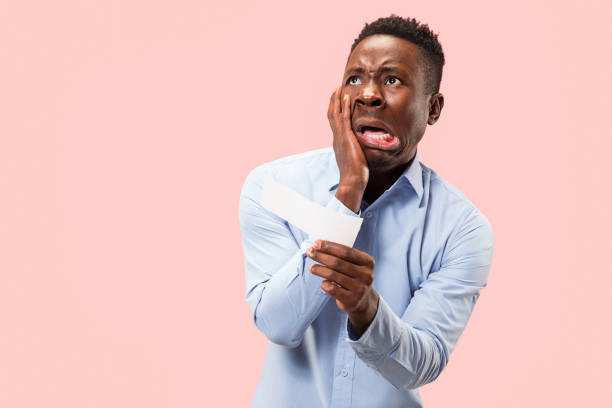 istock Young boy with a surprised expression bet slip on pink background 1097963356